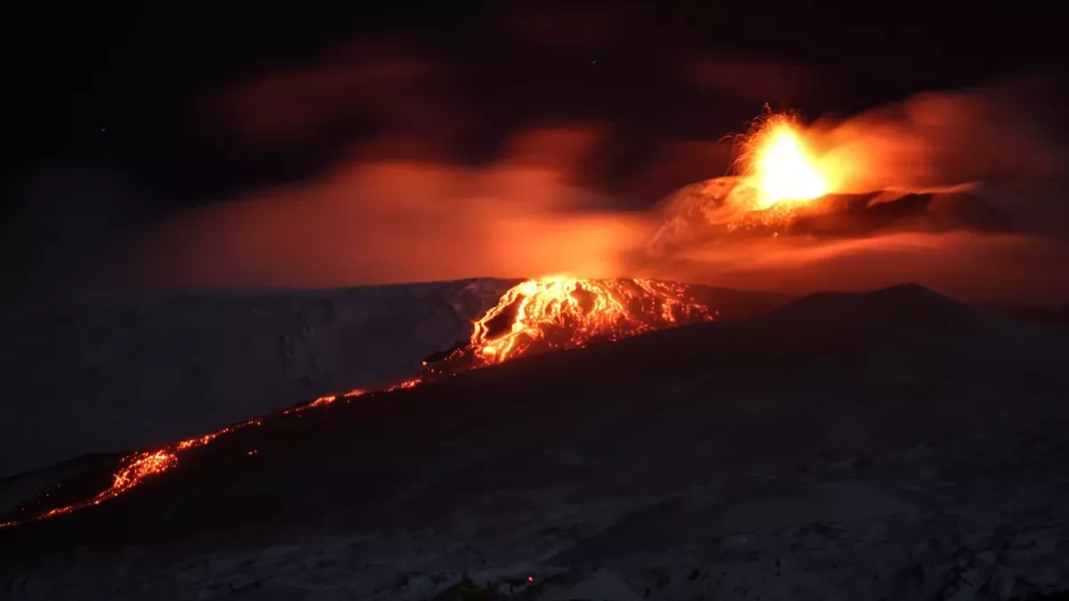 Lava flows and flaming rock rain, images from mount Etna's latest eruption