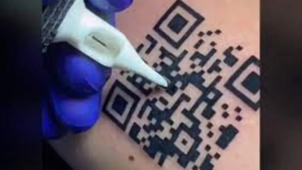 Man tattoos proof of vaccination QR code on arm
