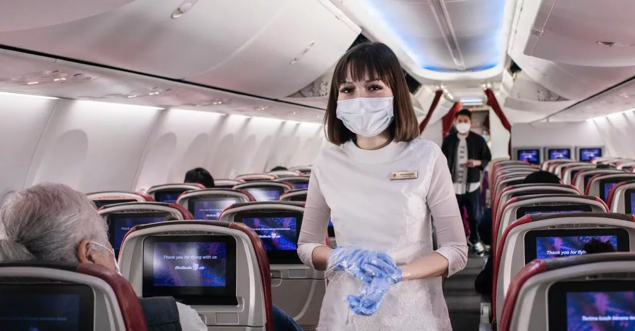 Tensions turn to panic after a woman was tackled by Thai Airways crew after she deliberately coughs on a stewardess