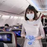 Tensions turn to panic after a woman was tackled by Thai Airways crew after she deliberately coughs on a stewardess