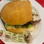 Woman chews on rotting finger while eating hamburger