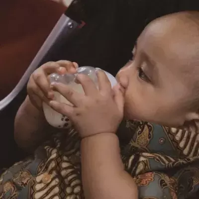 A baby drinks coffee instead of milk