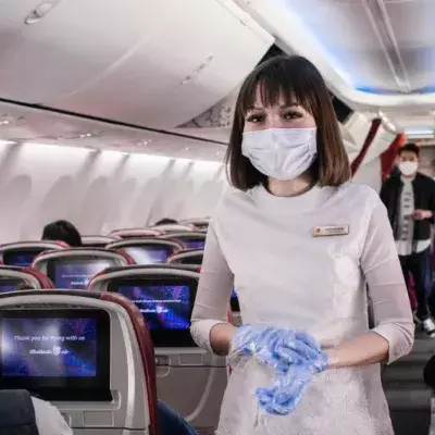 Tensions turn to panic after a woman was tackled by Thai Airways crew after she deliberately coughs on a stewardess